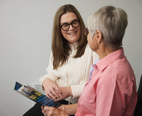 Audiologist discussing hearing care with an older patient