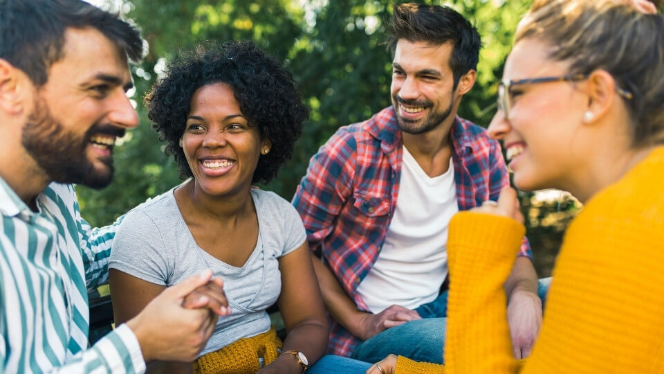 Group of adults enjoying a conversation outdoors